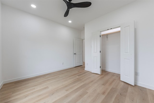 unfurnished bedroom featuring light hardwood / wood-style flooring, a closet, and ceiling fan