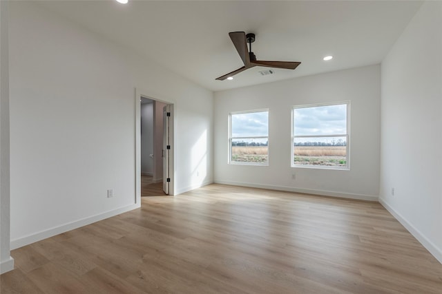 spare room with ceiling fan and light hardwood / wood-style floors