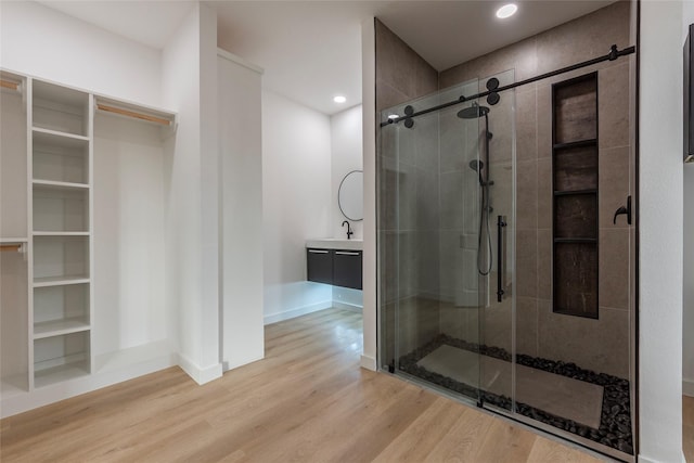 bathroom featuring vanity, an enclosed shower, and hardwood / wood-style floors