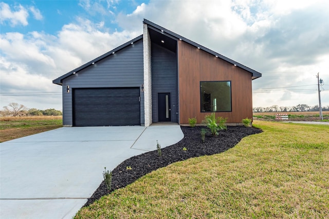 view of home's exterior with a yard and a garage