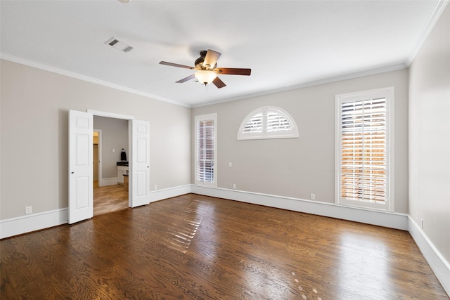 unfurnished room featuring crown molding, ceiling fan, a healthy amount of sunlight, and dark hardwood / wood-style floors