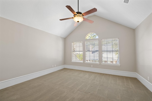 carpeted empty room with vaulted ceiling and ceiling fan