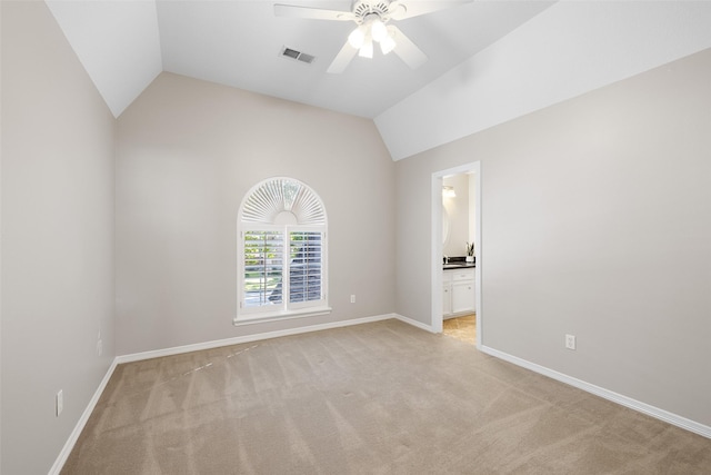 carpeted empty room featuring vaulted ceiling and ceiling fan