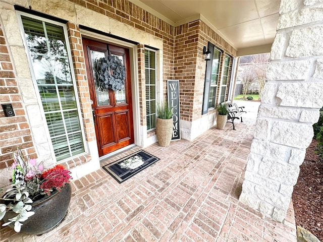 property entrance featuring brick siding