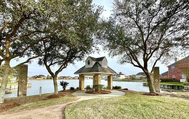 view of home's community with a lawn, a water view, and a gazebo