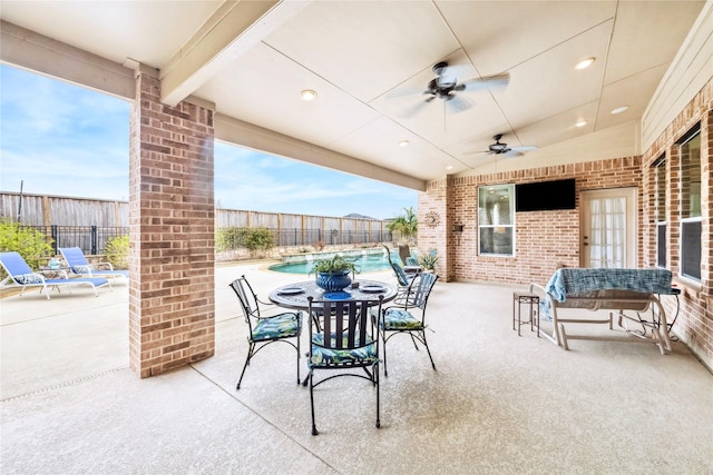 view of patio / terrace with ceiling fan, a fenced backyard, and a fenced in pool