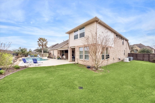 rear view of house with a fenced in pool, brick siding, a lawn, central AC, and a fenced backyard