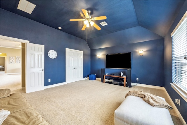 carpeted cinema room with visible vents, vaulted ceiling, baseboards, and ceiling fan