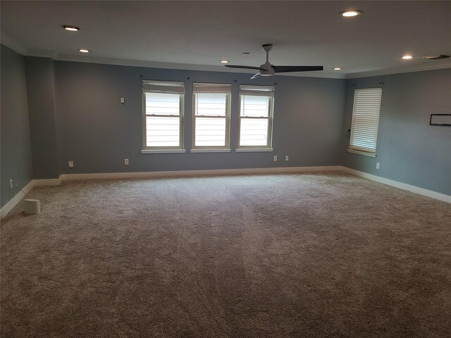 carpeted empty room featuring crown molding and ceiling fan