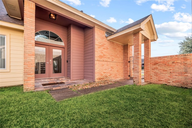 doorway to property with french doors and a yard