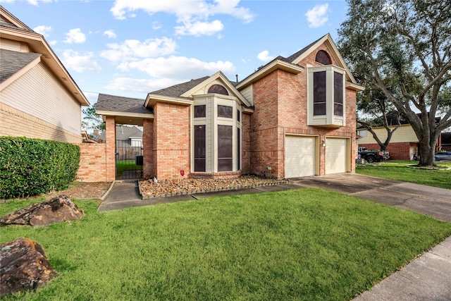 view of front of property with a garage and a front lawn