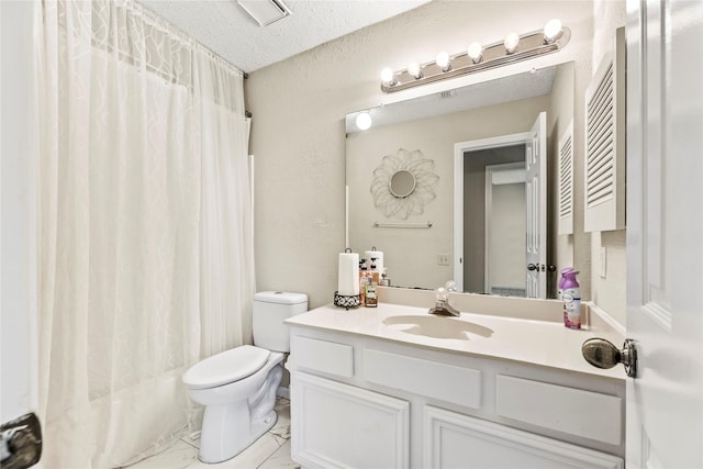 bathroom with vanity, toilet, and a textured ceiling