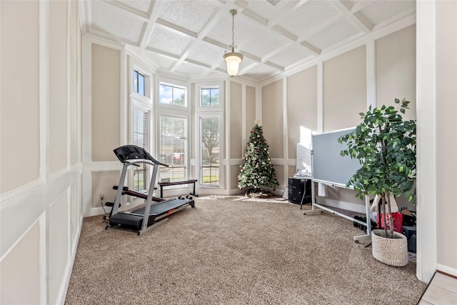 exercise room with coffered ceiling and carpet