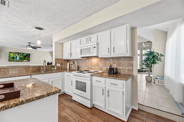 kitchen featuring white cabinetry, sink, and white appliances