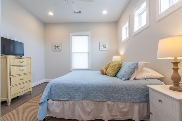 bedroom with dark wood-style floors, recessed lighting, visible vents, and baseboards