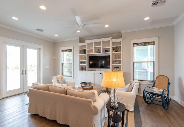 living room with a wealth of natural light, french doors, wood finished floors, and visible vents