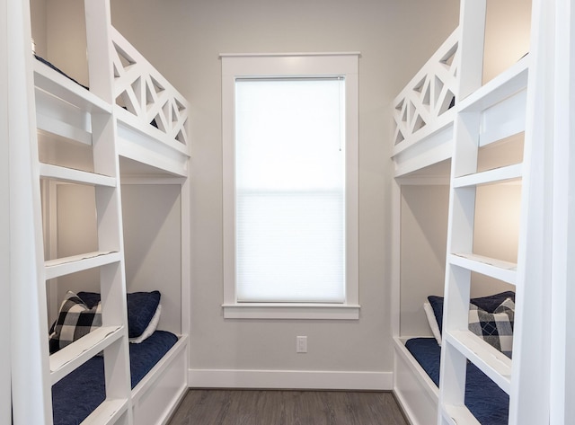 mudroom featuring dark wood finished floors and baseboards