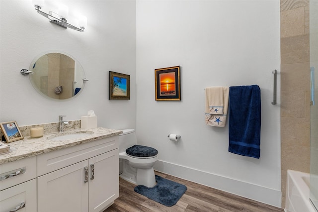 bathroom with hardwood / wood-style flooring, vanity, and toilet