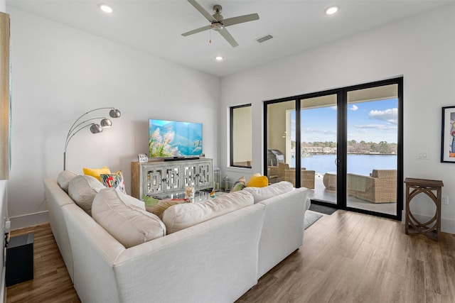 living room with wood-type flooring and ceiling fan