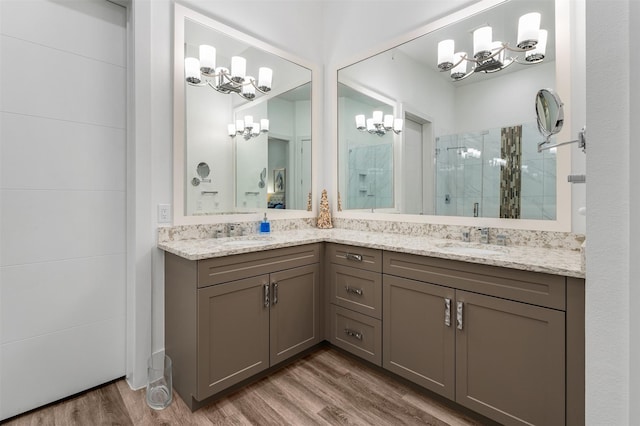 bathroom with walk in shower, vanity, and hardwood / wood-style floors