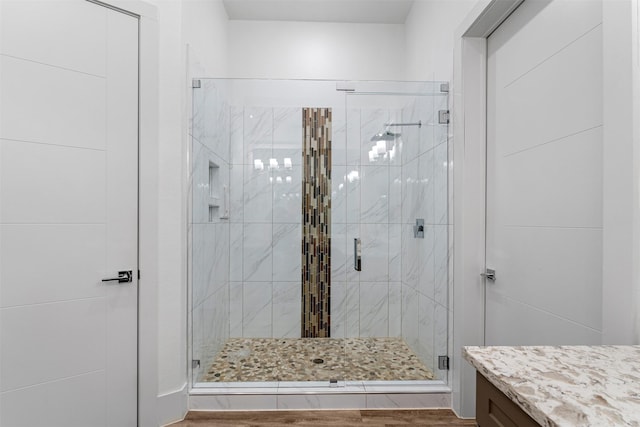 bathroom featuring vanity, an enclosed shower, and hardwood / wood-style floors