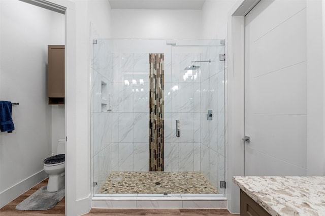 bathroom with hardwood / wood-style floors, vanity, toilet, a chandelier, and walk in shower