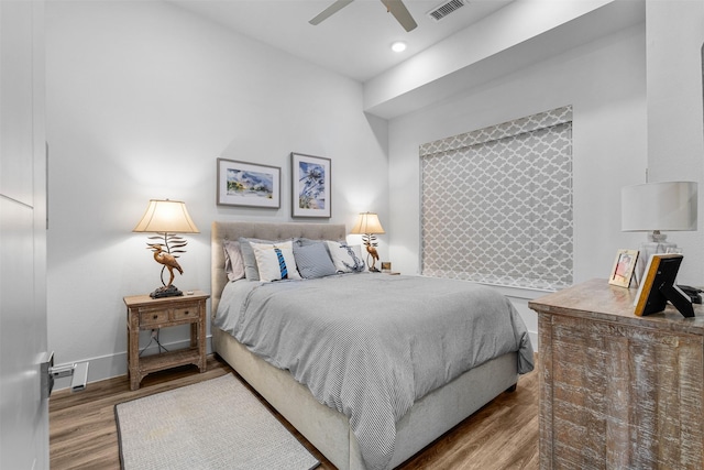 bedroom with hardwood / wood-style floors and ceiling fan