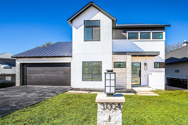 view of front of house featuring a garage and a front yard