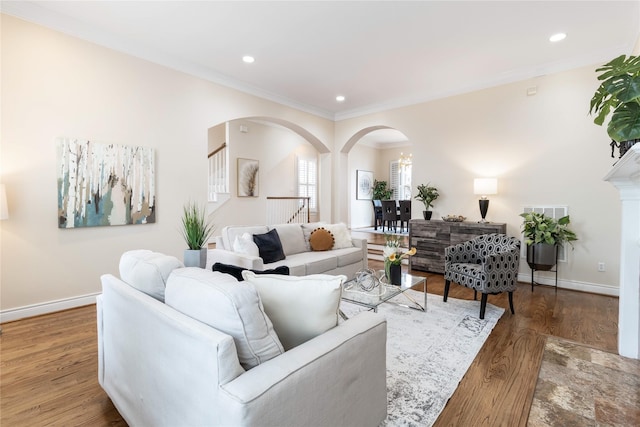 living room with hardwood / wood-style floors and crown molding