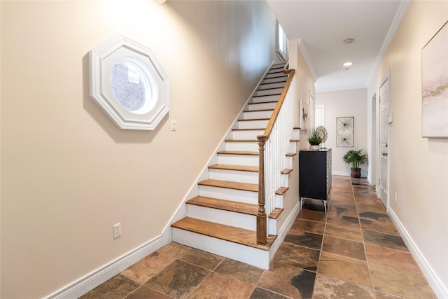 stairway featuring crown molding