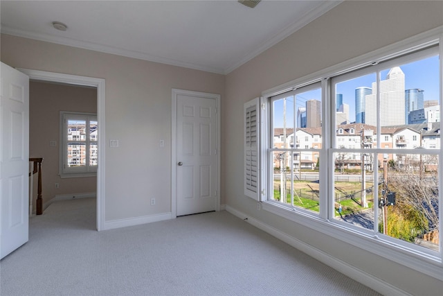 unfurnished bedroom with multiple windows, crown molding, and light carpet