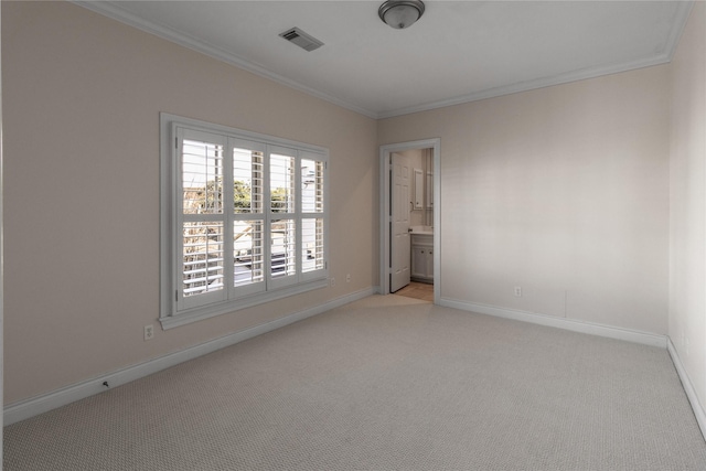 unfurnished room with ornamental molding and light carpet