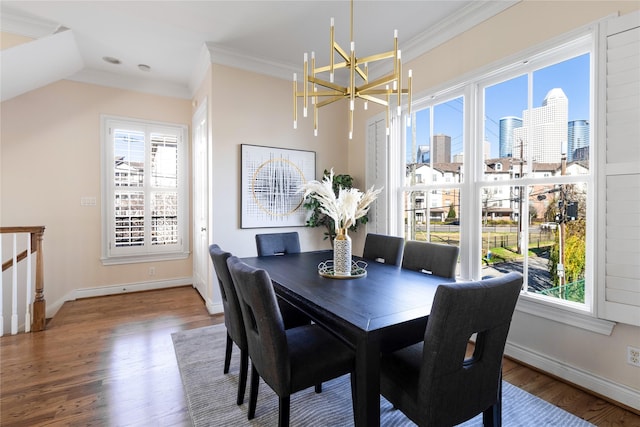 dining room featuring an inviting chandelier, ornamental molding, and wood-type flooring