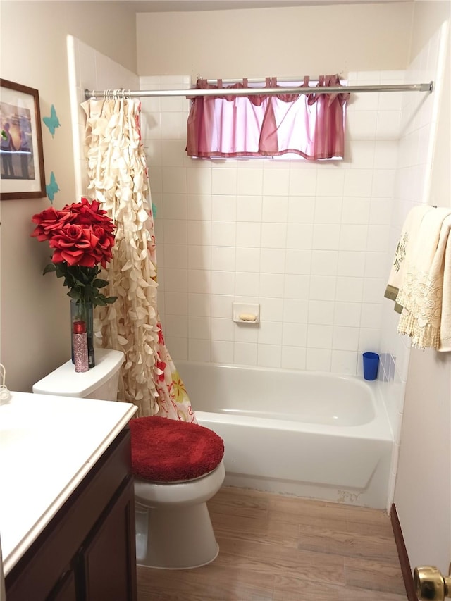 full bathroom featuring vanity, toilet, hardwood / wood-style floors, and shower / bath combo