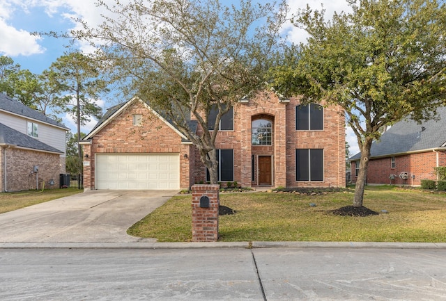 traditional home with driveway, brick siding, an attached garage, and a front yard