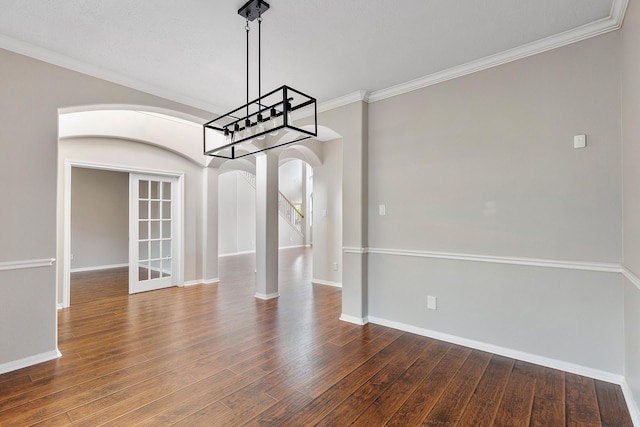 unfurnished dining area with ornamental molding, dark hardwood / wood-style floors, and french doors