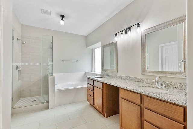 bathroom featuring tile patterned floors, vanity, and plus walk in shower