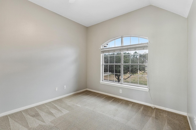 unfurnished room with lofted ceiling, carpet, and baseboards