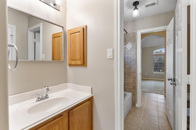 bathroom with vanity, tile patterned flooring, and shower / bath combination