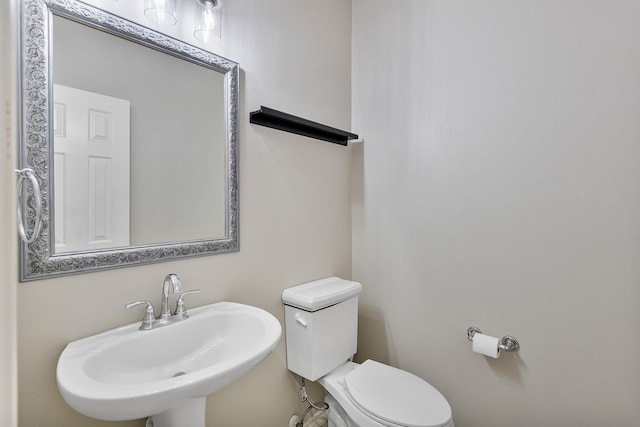 bathroom featuring toilet and sink