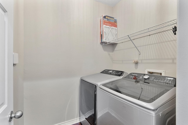 laundry room with washing machine and clothes dryer