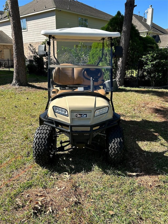 view of vehicle parking with a detached carport and fence