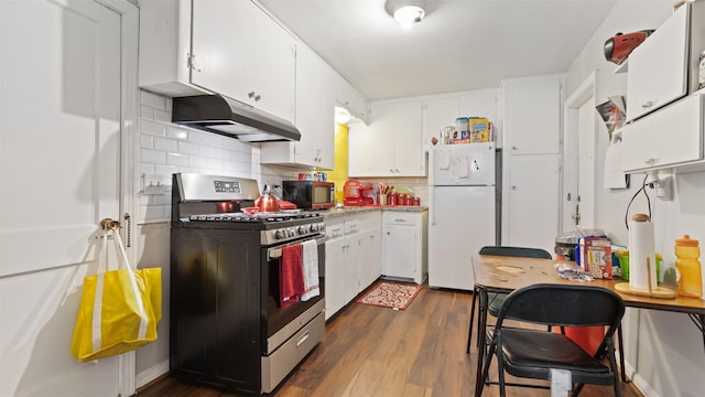 kitchen with white cabinetry, stainless steel gas range, dark hardwood / wood-style floors, and white fridge