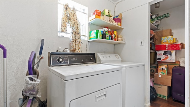 laundry room featuring dark hardwood / wood-style flooring and washing machine and clothes dryer