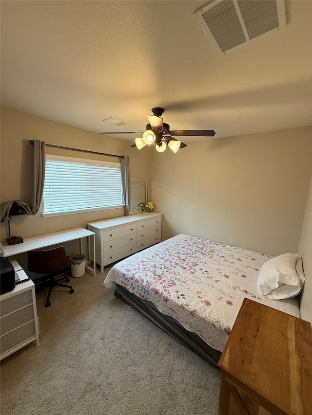 bedroom featuring ceiling fan and carpet