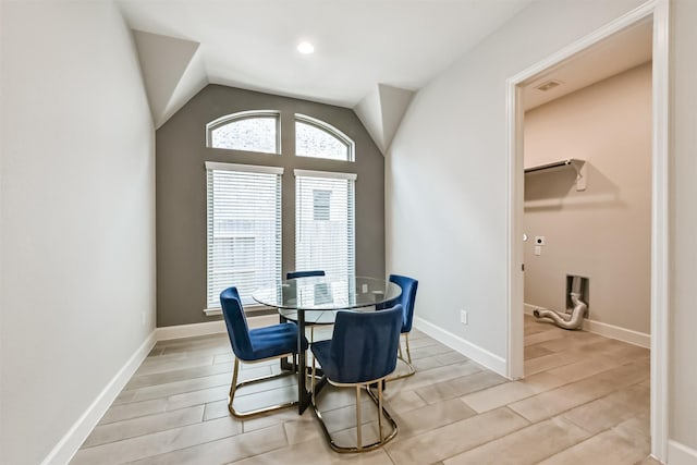 dining room featuring vaulted ceiling