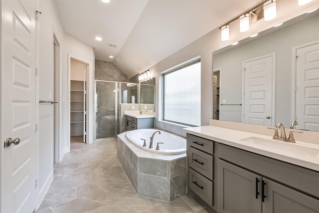 bathroom featuring vanity, lofted ceiling, and separate shower and tub