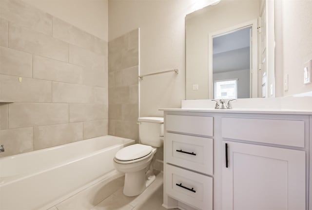 full bathroom featuring vanity, tiled shower / bath, and toilet