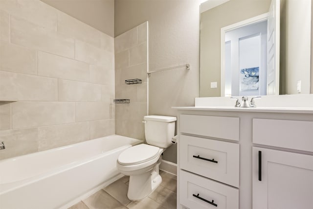 full bathroom featuring tiled shower / bath combo, vanity, tile patterned floors, and toilet