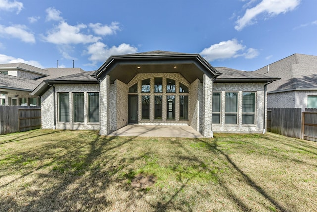 rear view of property with a yard and a patio